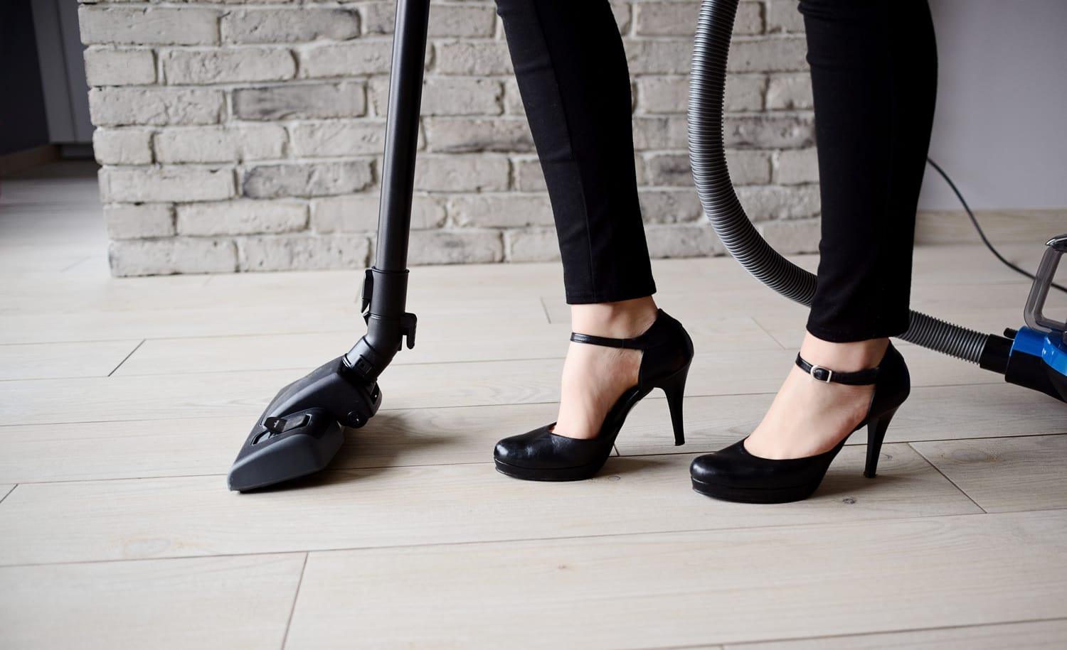 Lady with high heels vacuum cleaner - photo