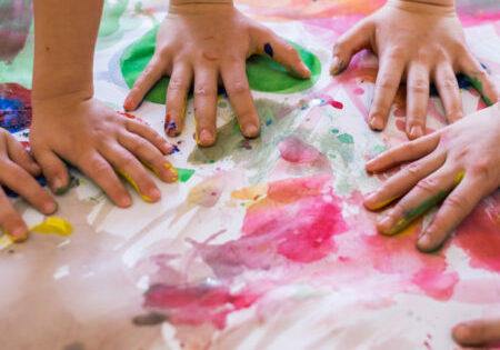 Close-up of children playing with paint